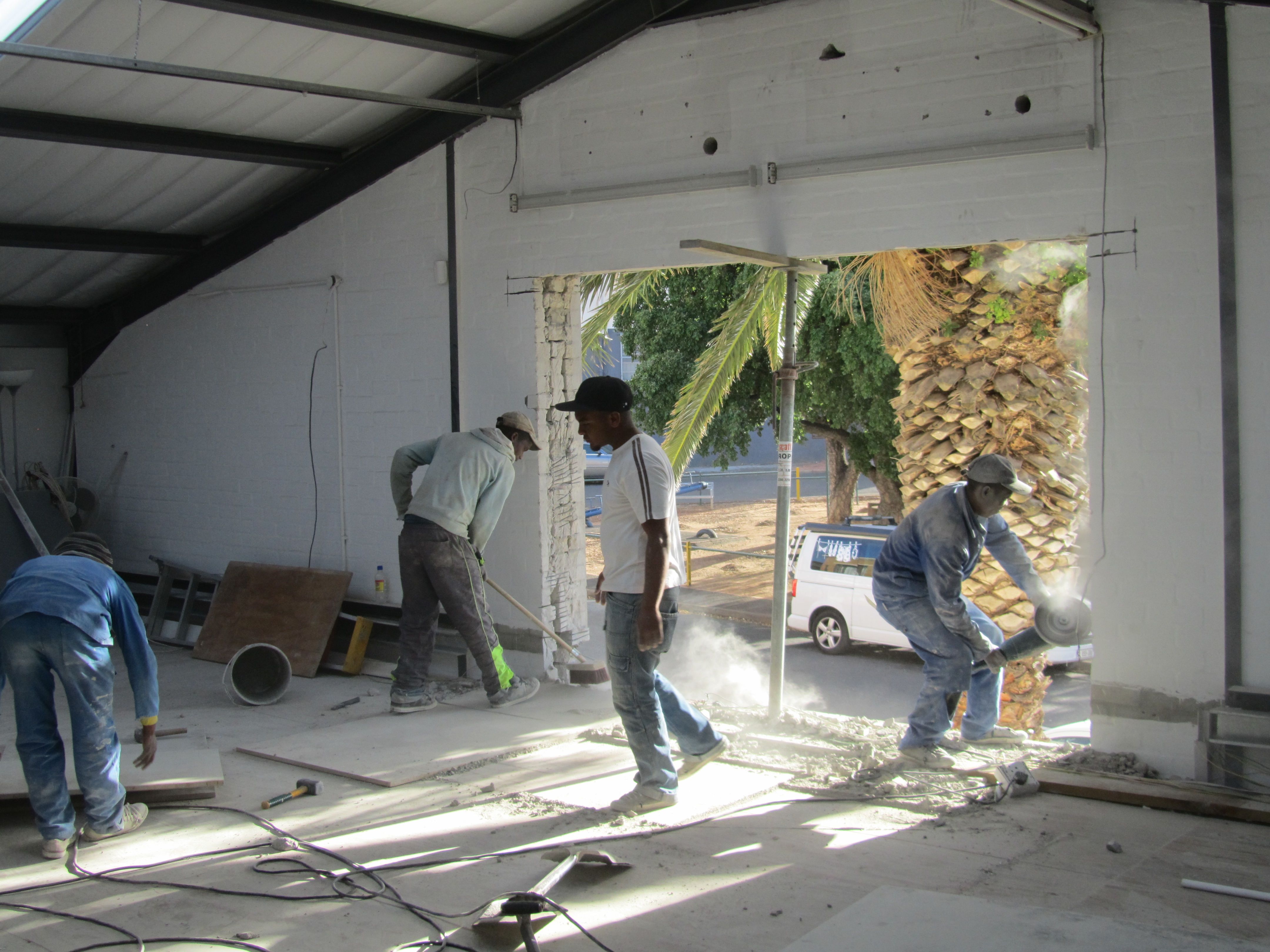 Hard at work to put stacker doors in the tasting room